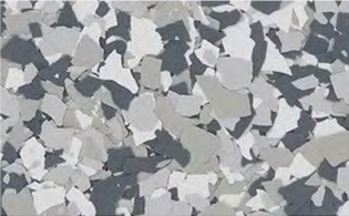 A surface with a scattered pattern of variously shaped gray, white, and black flakes.