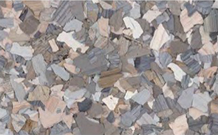 Close-up of a terrazzo floor with irregularly shaped gray, beige, and white stone chips set in a neutral background.