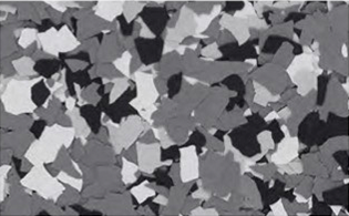A close-up view of a surface with irregular black, white, and gray speckled pattern resembling terrazzo or epoxy flooring.